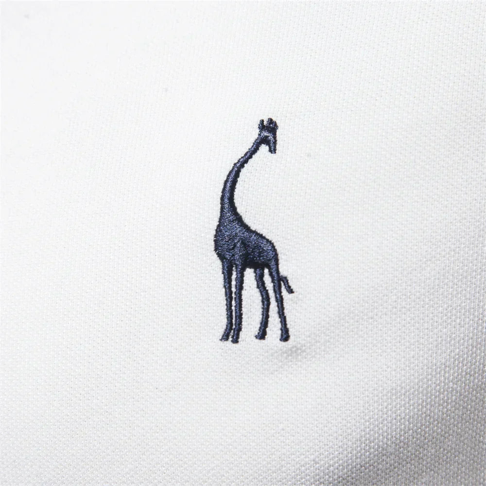 Embroidered giraffe design on a white fabric background