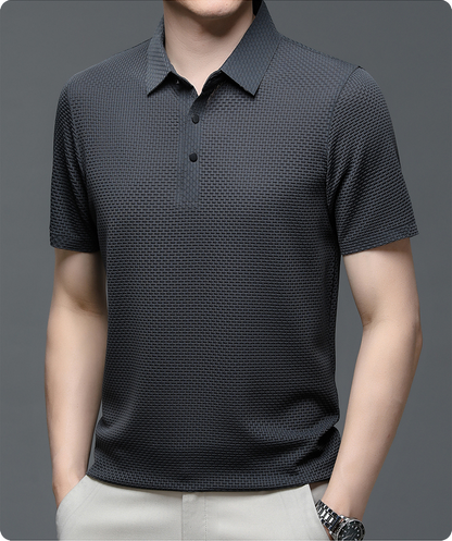 Black patterned polo shirt worn by a person on a gray background