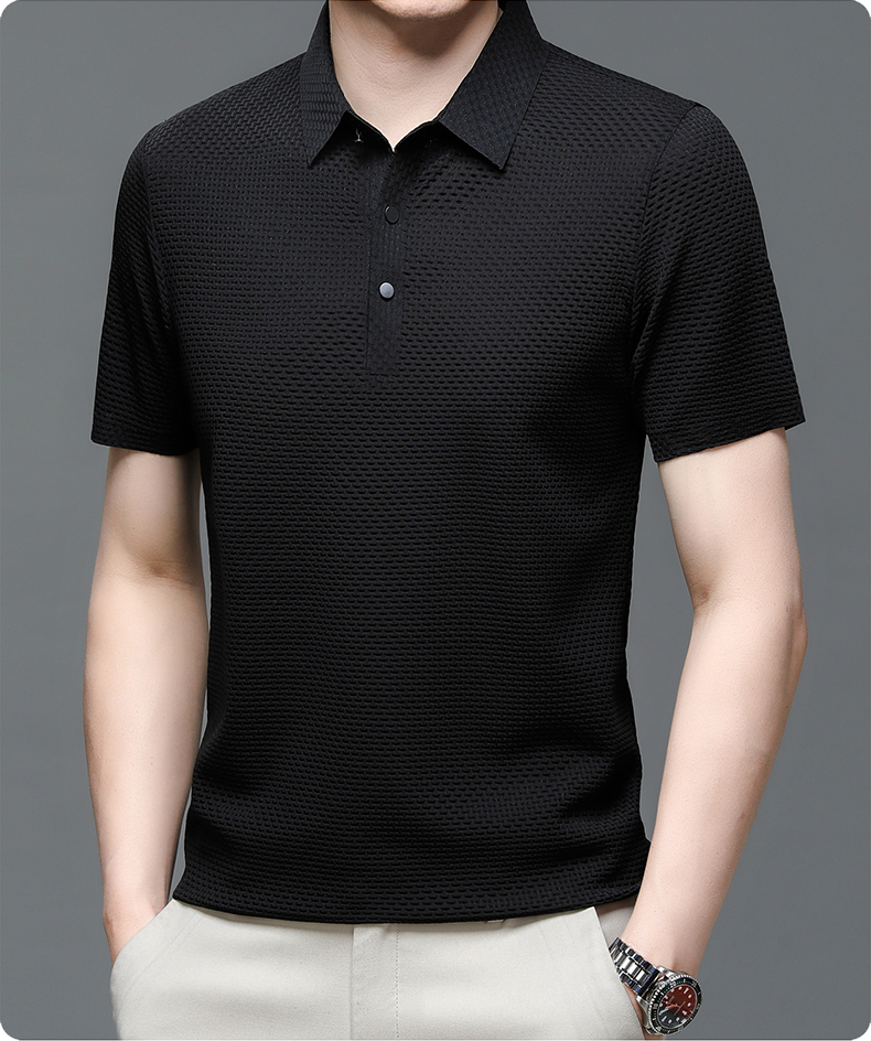 Black textured polo shirt worn by a person on a gray background