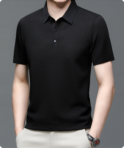 Black textured polo shirt worn by a person on a gray background