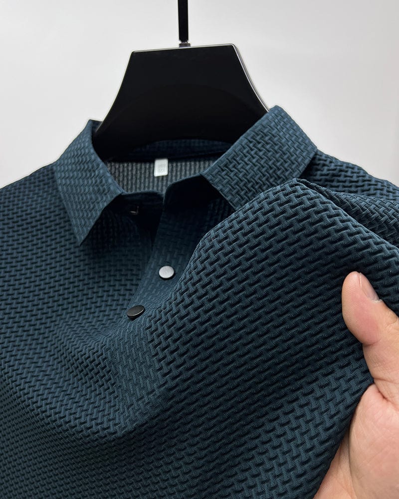 Blue textured polo shirt on a hanger with a hand holding it