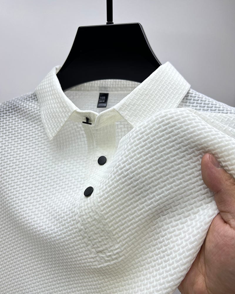 White textured shirt with black buttons on a hanger against a gray background