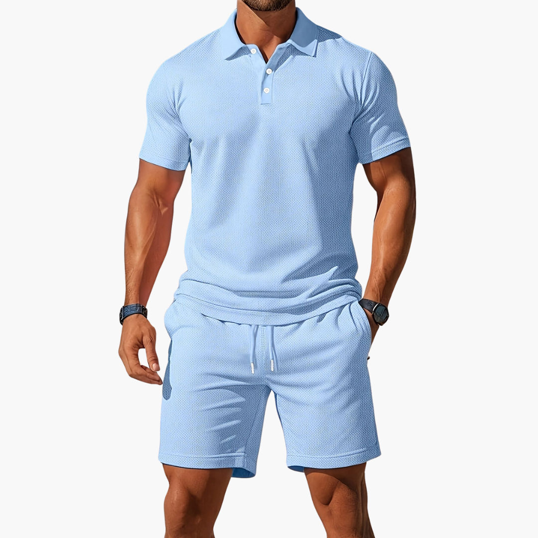 Man wearing a light blue polo shirt and shorts set on a white background