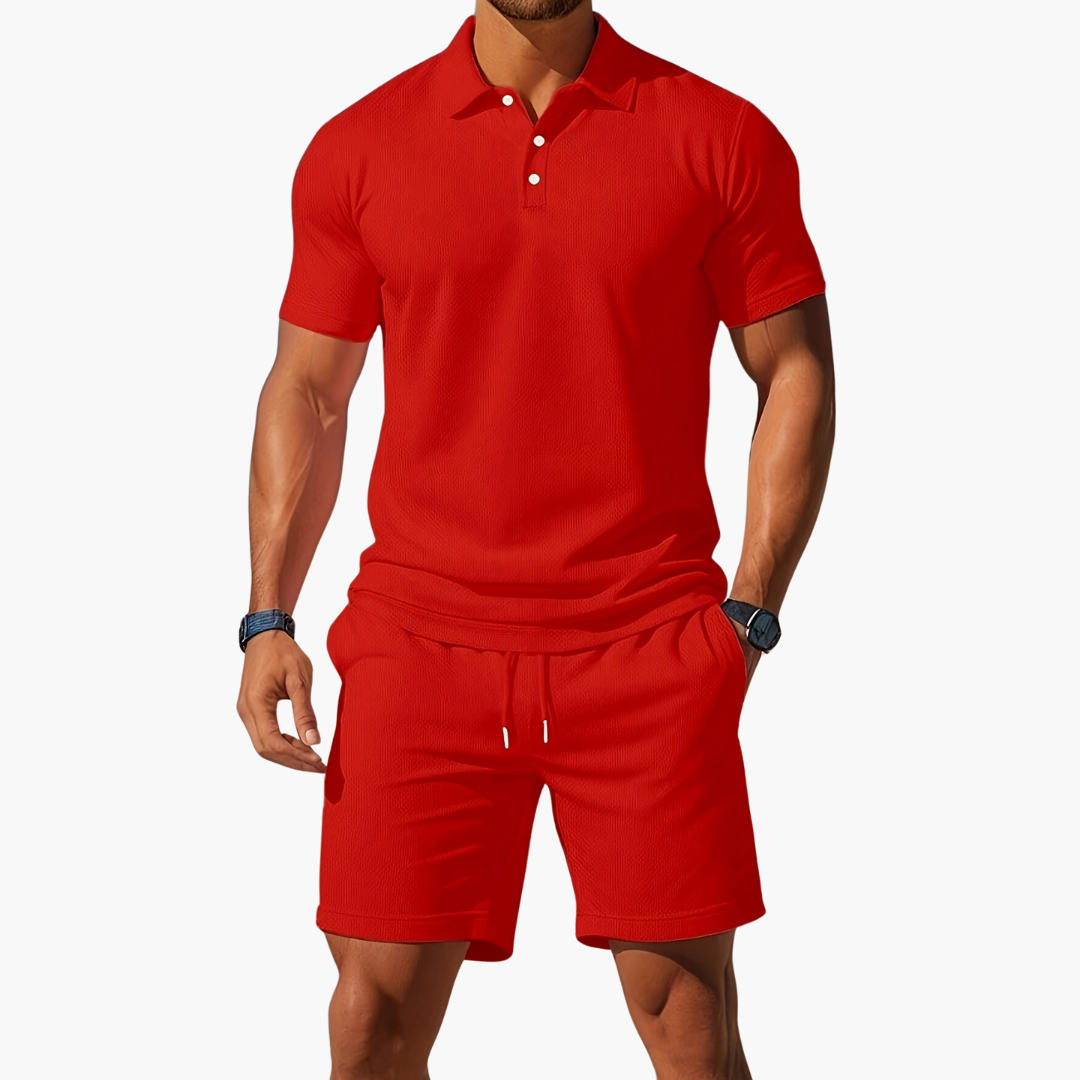 Man wearing a red polo shirt and shorts set on a white background