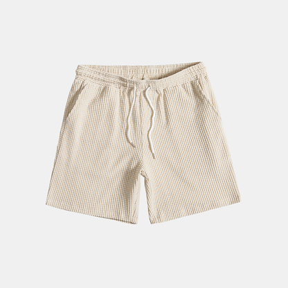 Beige shorts with a drawstring on a light gray background