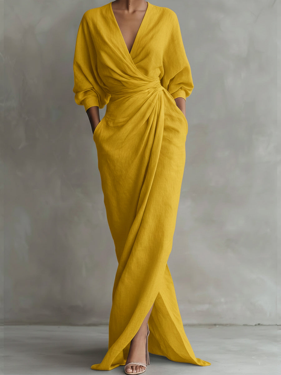 Mustard yellow dress with a deep V-neck and long sleeves on a gray background