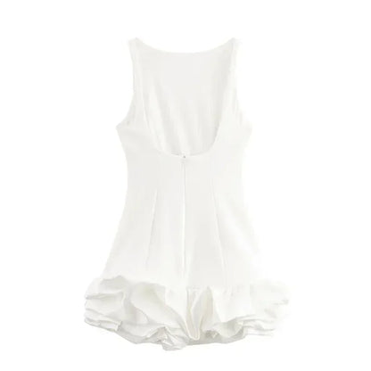 White sleeveless dress with ruffled hem on a white background