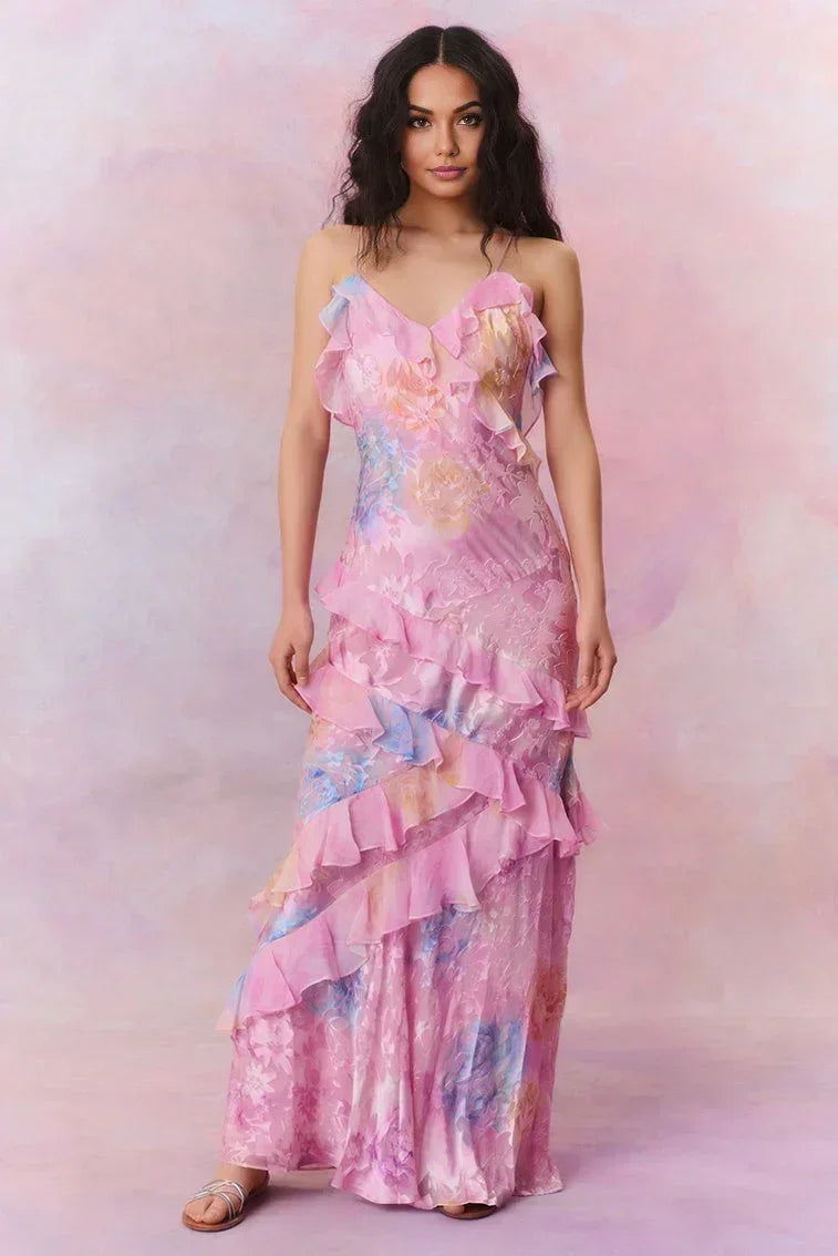 Woman wearing a pink floral dress against a soft pink background