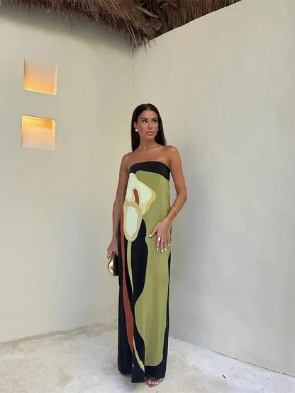 Woman in a strapless dress with abstract design standing indoors.