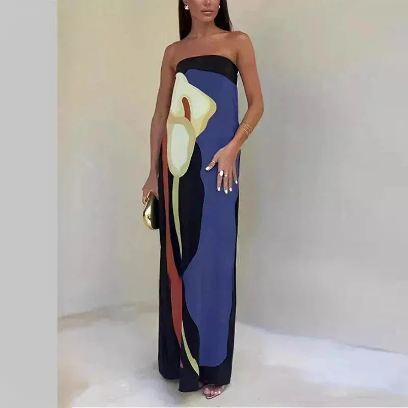 Woman wearing a strapless dress with abstract design on a plain background