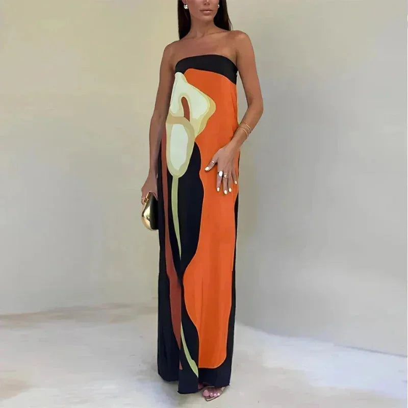 Woman wearing a strapless dress with abstract design on a plain background