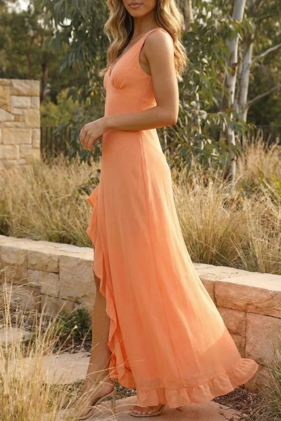 Woman wearing a peach-colored dress standing outdoors with natural background