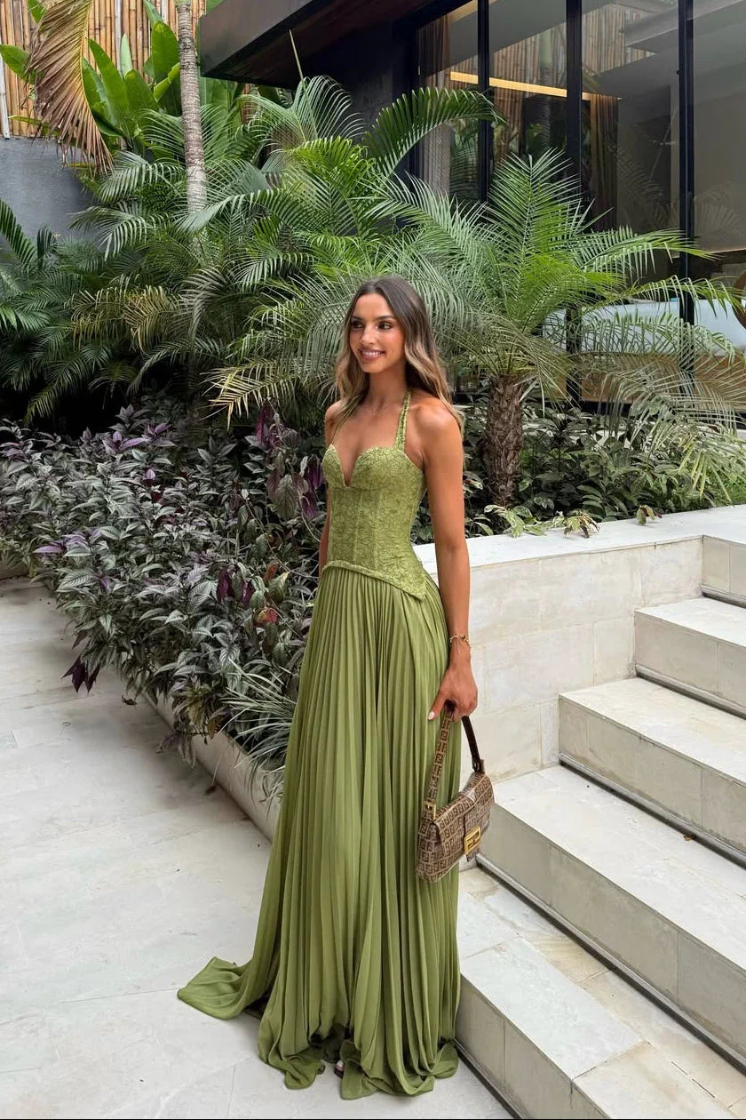 Woman in a green dress standing in a garden setting