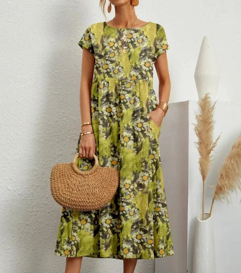 Woman wearing a floral dress holding a woven handbag against a neutral background