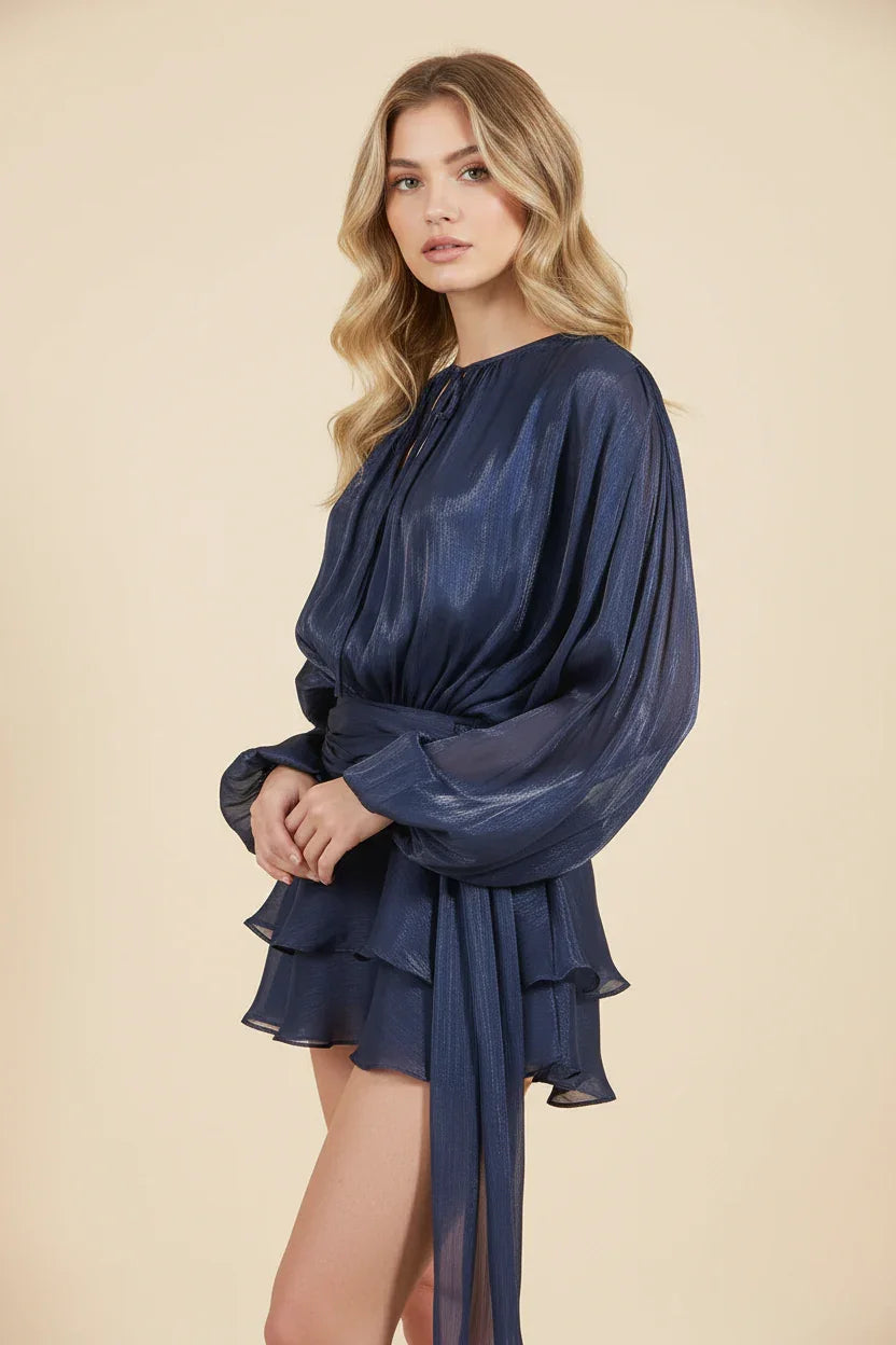 Woman wearing a blue dress against a beige background