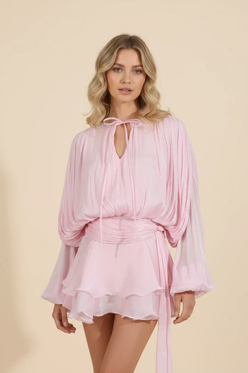 Woman wearing a pink dress against a beige background