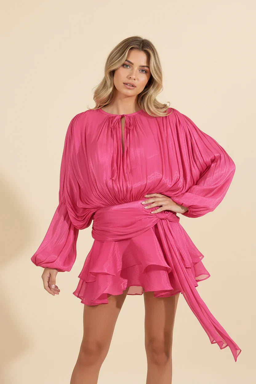 Woman wearing a pink dress against a beige background