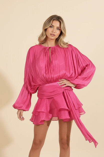 Woman wearing a pink dress against a beige background