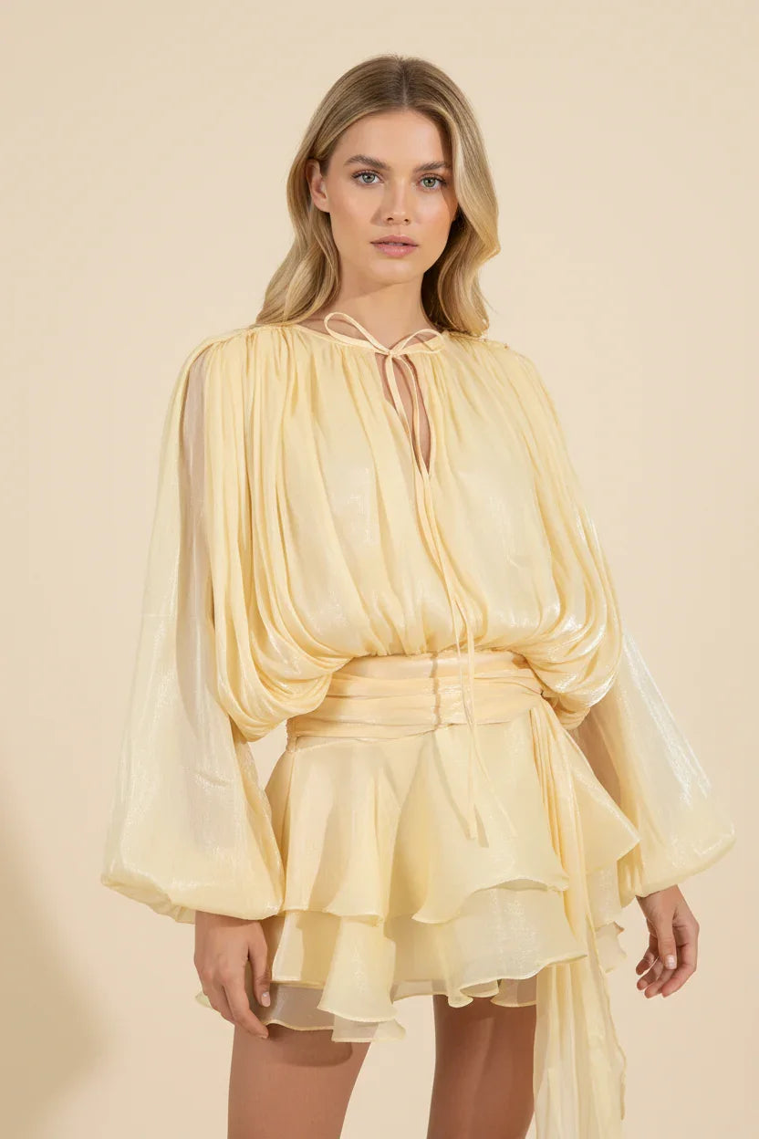Woman wearing a yellow dress against a beige background