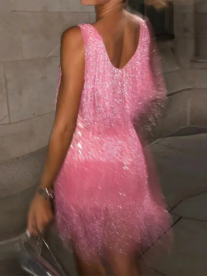 Person wearing a pink sparkly dress in an indoor setting