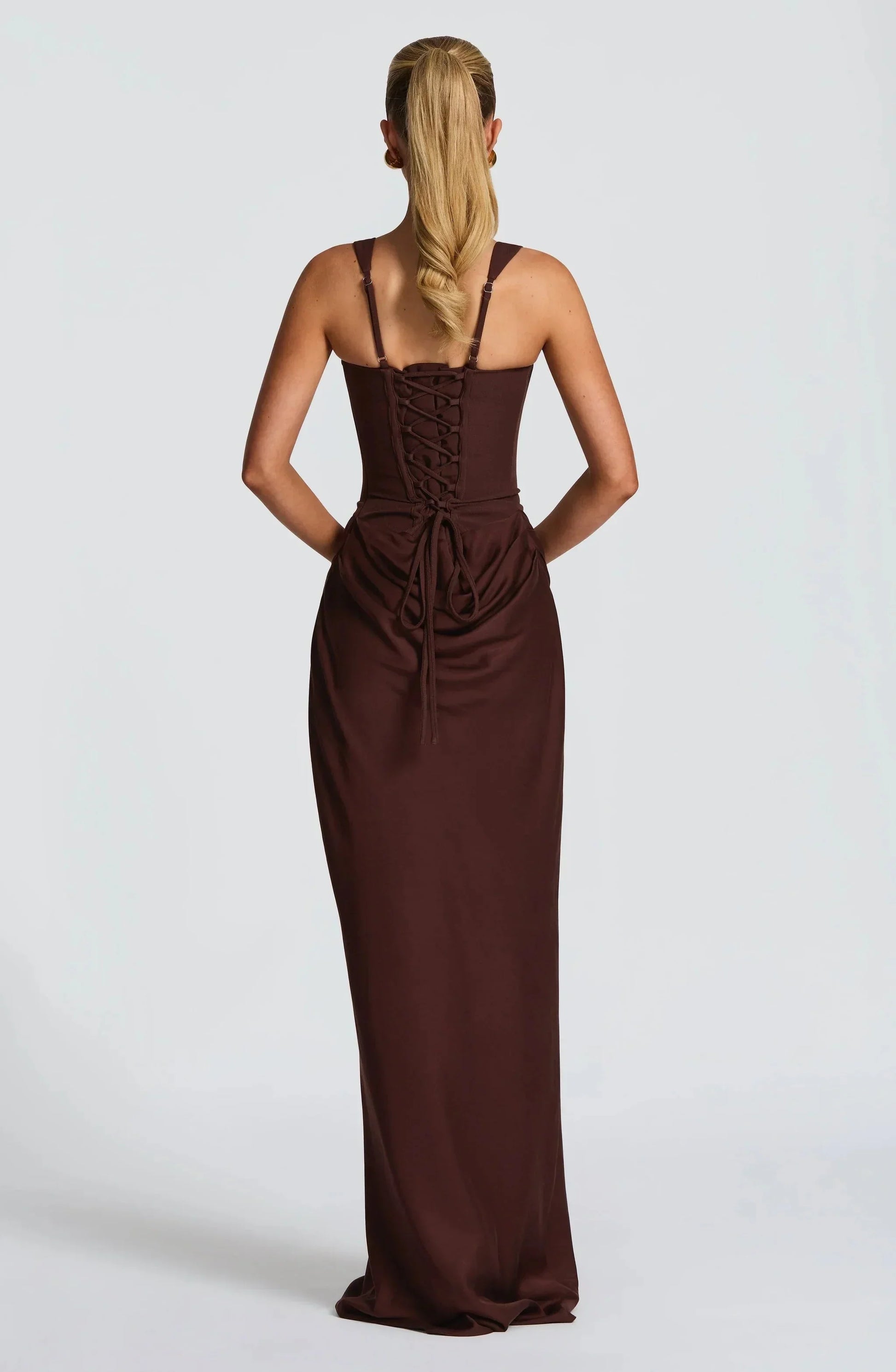Brown evening gown with lace-up back on a white background