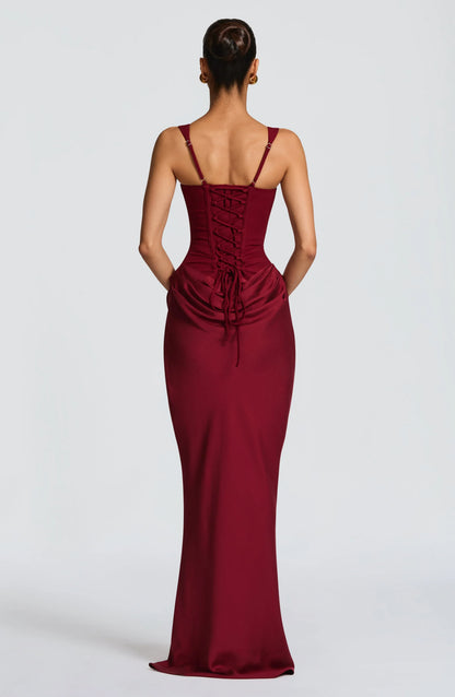 Burgundy evening gown with a corset-style back on a white background