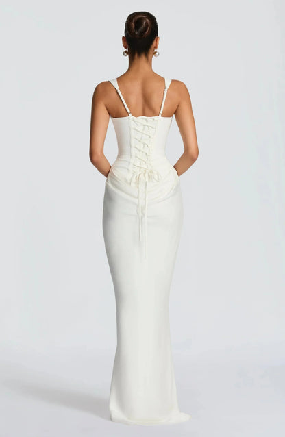 Woman wearing a white evening gown with a plain background