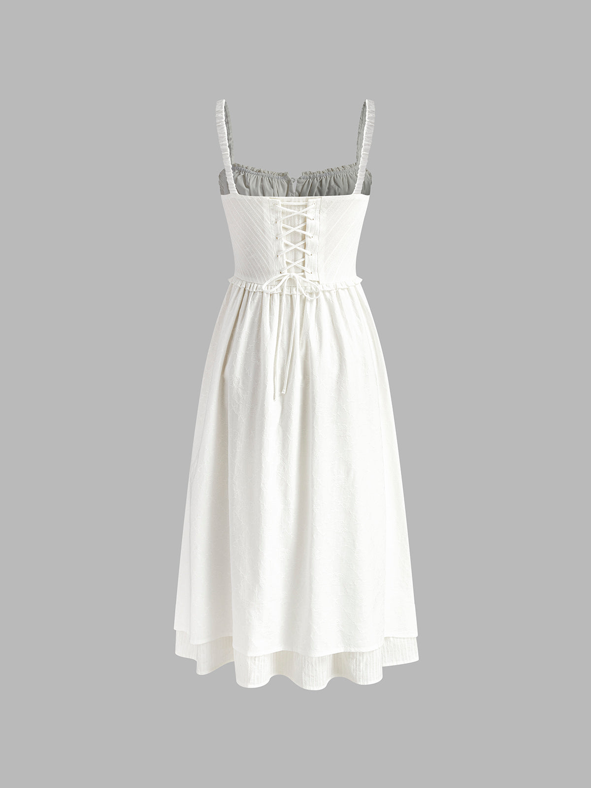 White dress with lace-up front on a gray background