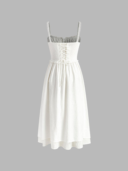 White dress with lace-up front on a gray background