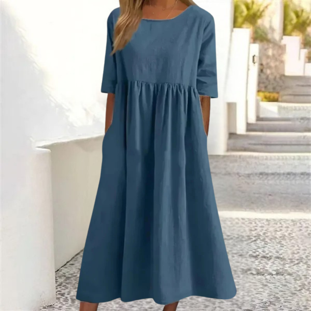 Blue dress worn by a person standing outdoors.