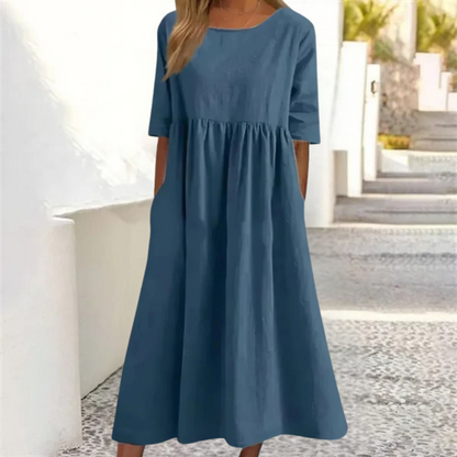 Blue dress worn by a person standing outdoors.