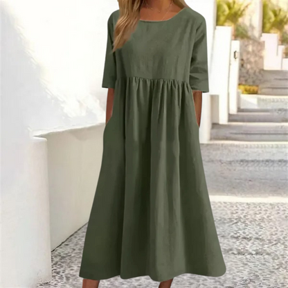 Green dress worn by a person standing outdoors with a blurred background