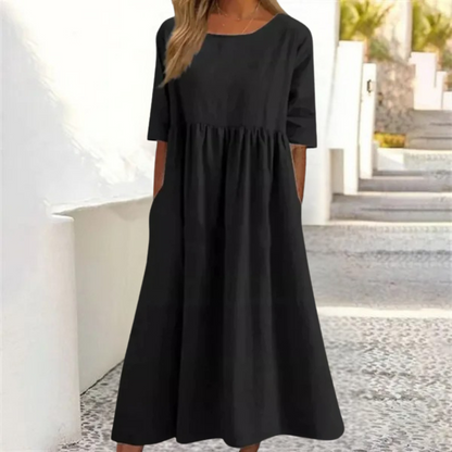 Black dress worn by a person standing outdoors.