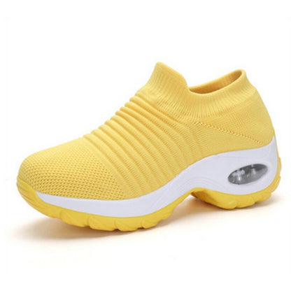 Yellow sneaker with white sole on a white background