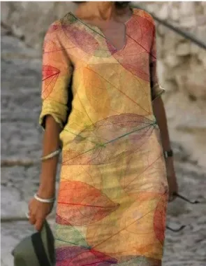 Person wearing a colorful dress with abstract patterns on a blurred natural background