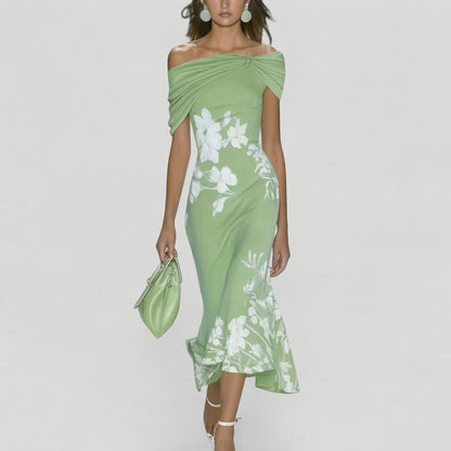 Woman wearing a green floral dress with a white background