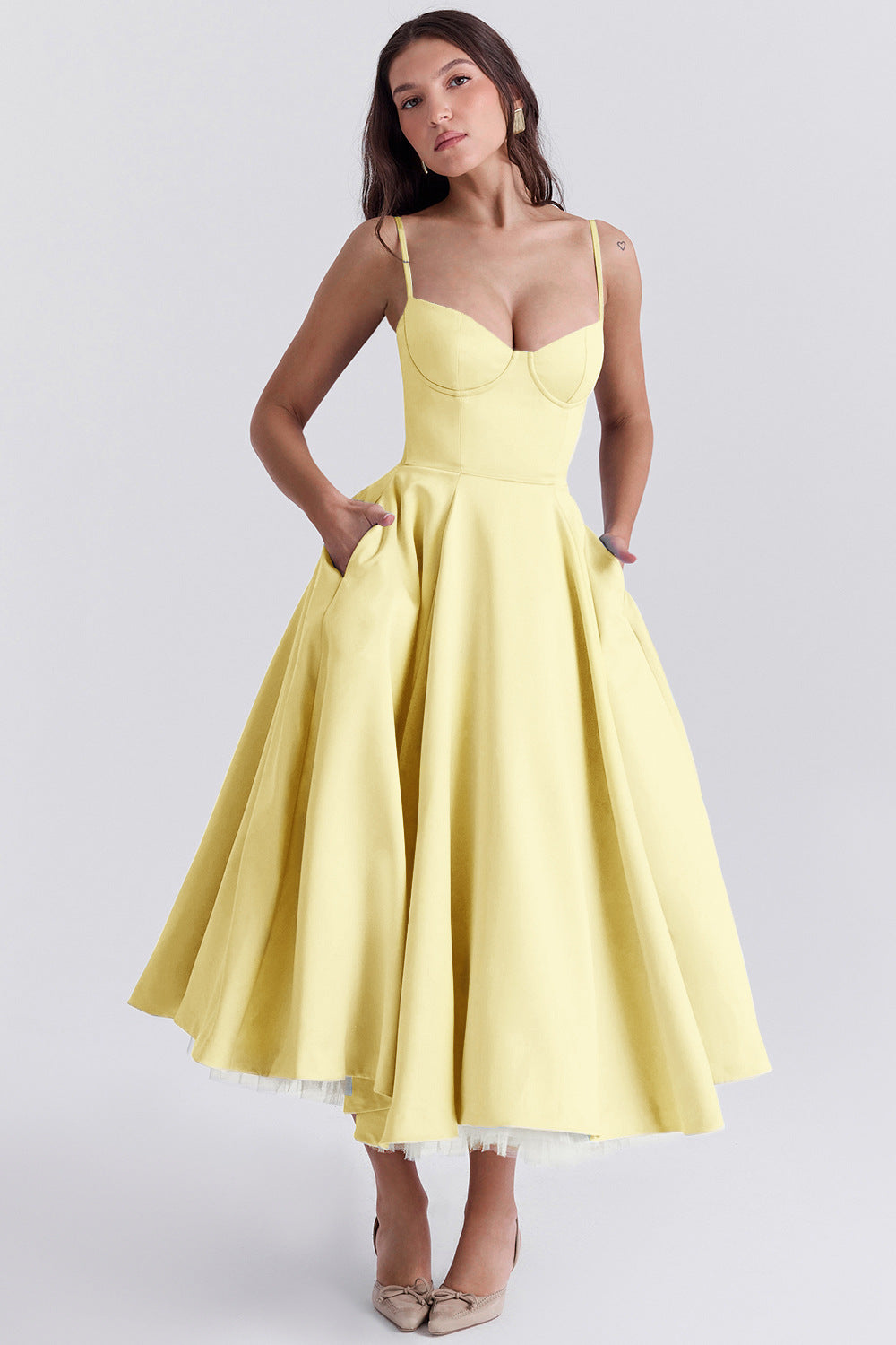 Woman wearing a yellow dress on a white background